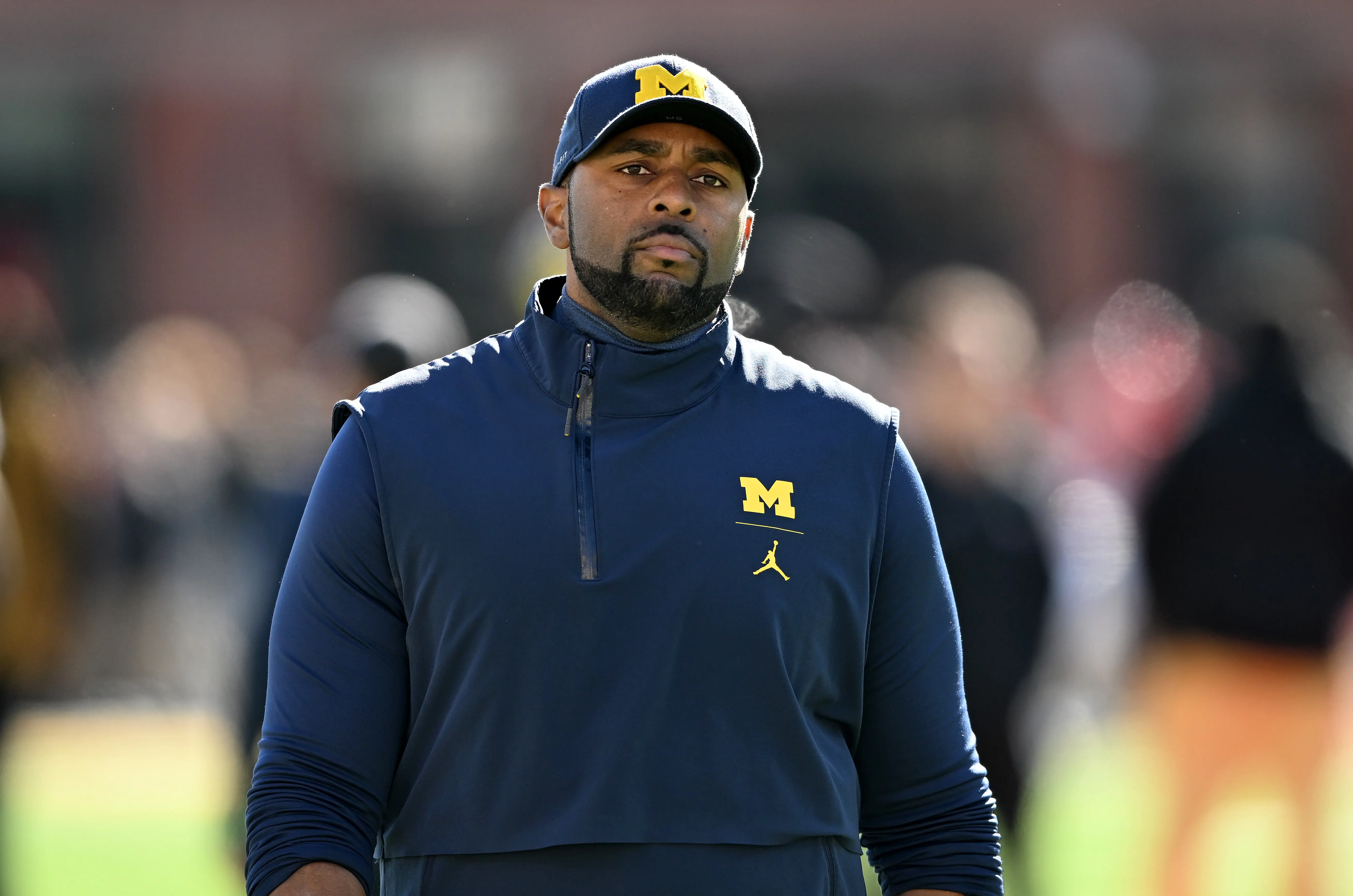 COLLEGE PARK, MARYLAND - NOVEMBER 18: Acting head coach Sherrone Moore of the Michigan Wolverines watches the teams warm up before the game against the Maryland Terrapins at SECU Stadium on November 18, 2023 in College Park, Maryland. (Photo by Greg Fiume/Getty Images)