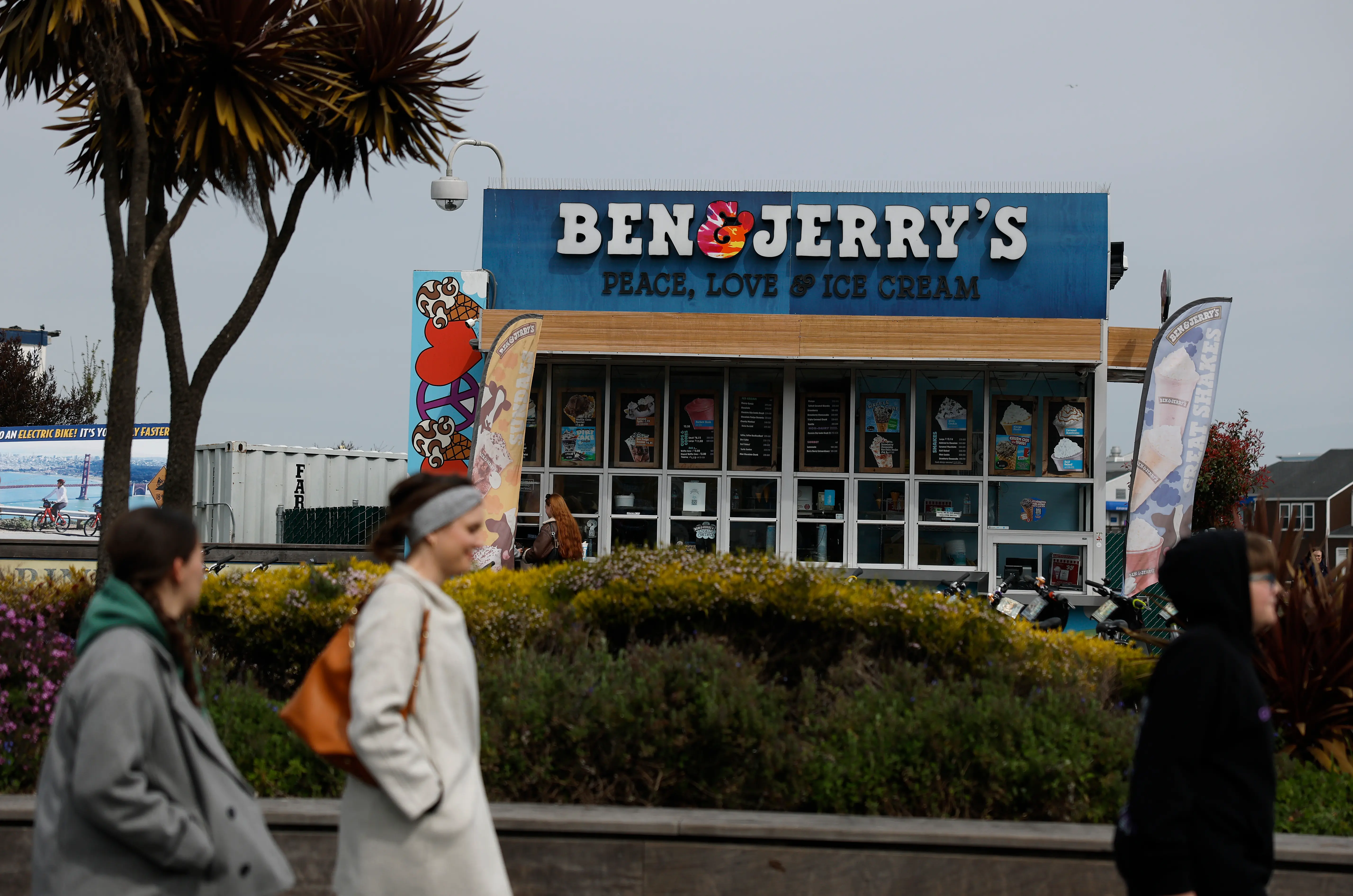 SAN FRANCISCO, CALIFORNIA - MARCH 19: People walk by a Ben and Jerry's ice cream shop on March 19, 2025 in San Francisco, California. Ice cream maker Ben and Jerry's is accusing its parent company, Unilever, of dismissing CEO David Stever for supporting Ben and Jerry's political activism. (Photo by Justin Sullivan/Getty Images)