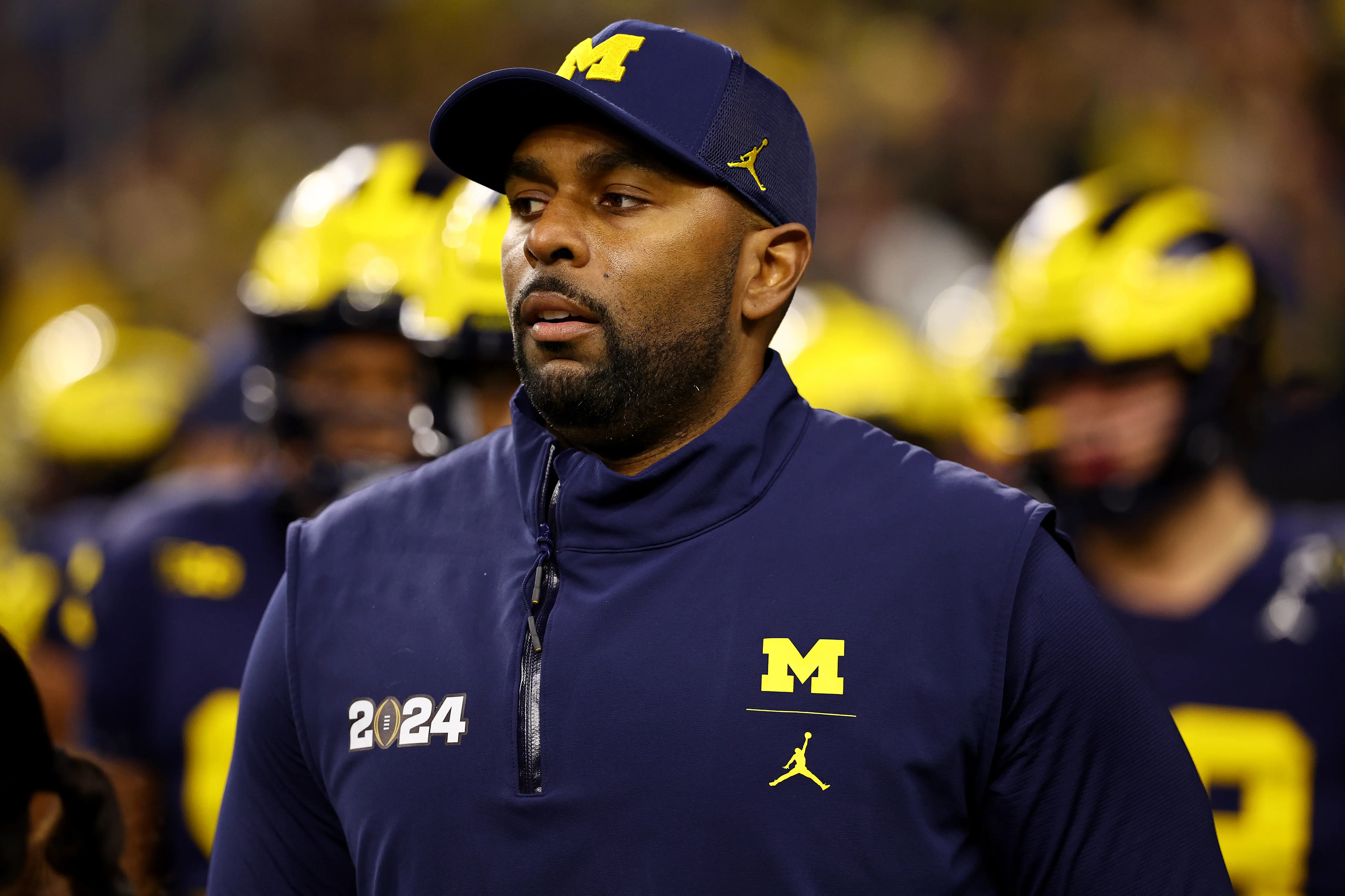 HOUSTON, TEXAS - JANUARY 8: Offensive coordinator Sherrone Moore of the Michigan Wolverines takes the field against the Washington Huskies during the 2024 CFP National Championship game at NRG Stadium on January 8, 2024 in Houston, Texas. (Photo by Jamie Schwaberow/Getty Images)