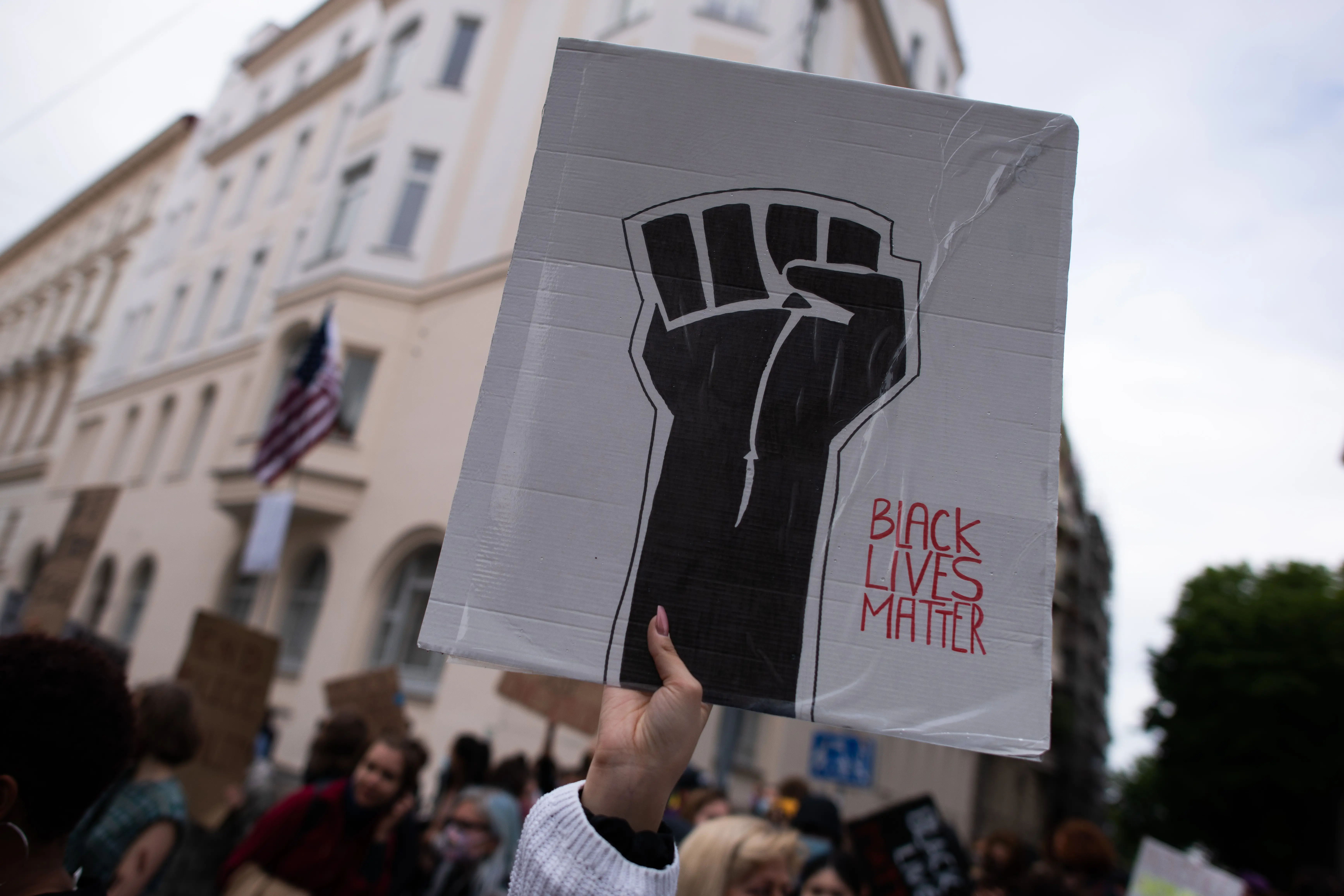 A protester holds up a sign showing a fist and reading 'Black Lives Matter' during a Black Lives Matter protest in front of the U.S Embassy on June 05, 2020 in Vienna, Austria. The death of an African-American man, George Floyd, while in the custody of Minneapolis police has sparked protests across the United States, as well as demonstrations of solidarity in many countries around the world. (Photo by Thomas Kronsteiner/Getty Images)