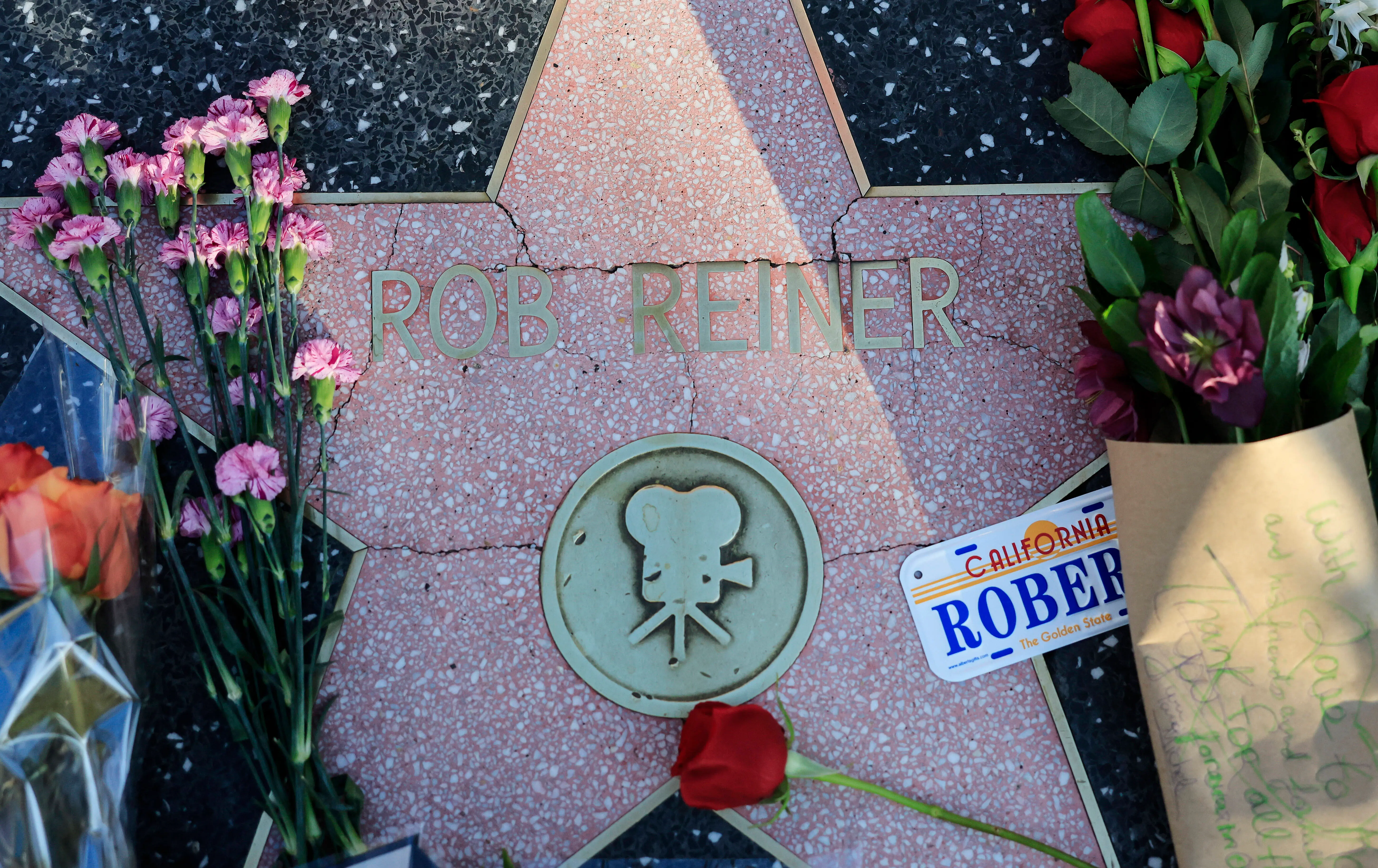 Flowers rest on Rob Reiner's star on the Hollywood Walk of Fame on December 15, 2025 in Los Angeles, California. The LAPD confirmed that Rob Reiner and his wife Michele Singer Reiner were found dead in their Brentwood home. Their son Nick has been arrested in connection to their deaths. (Photo by Mario Tama/Getty Images)
