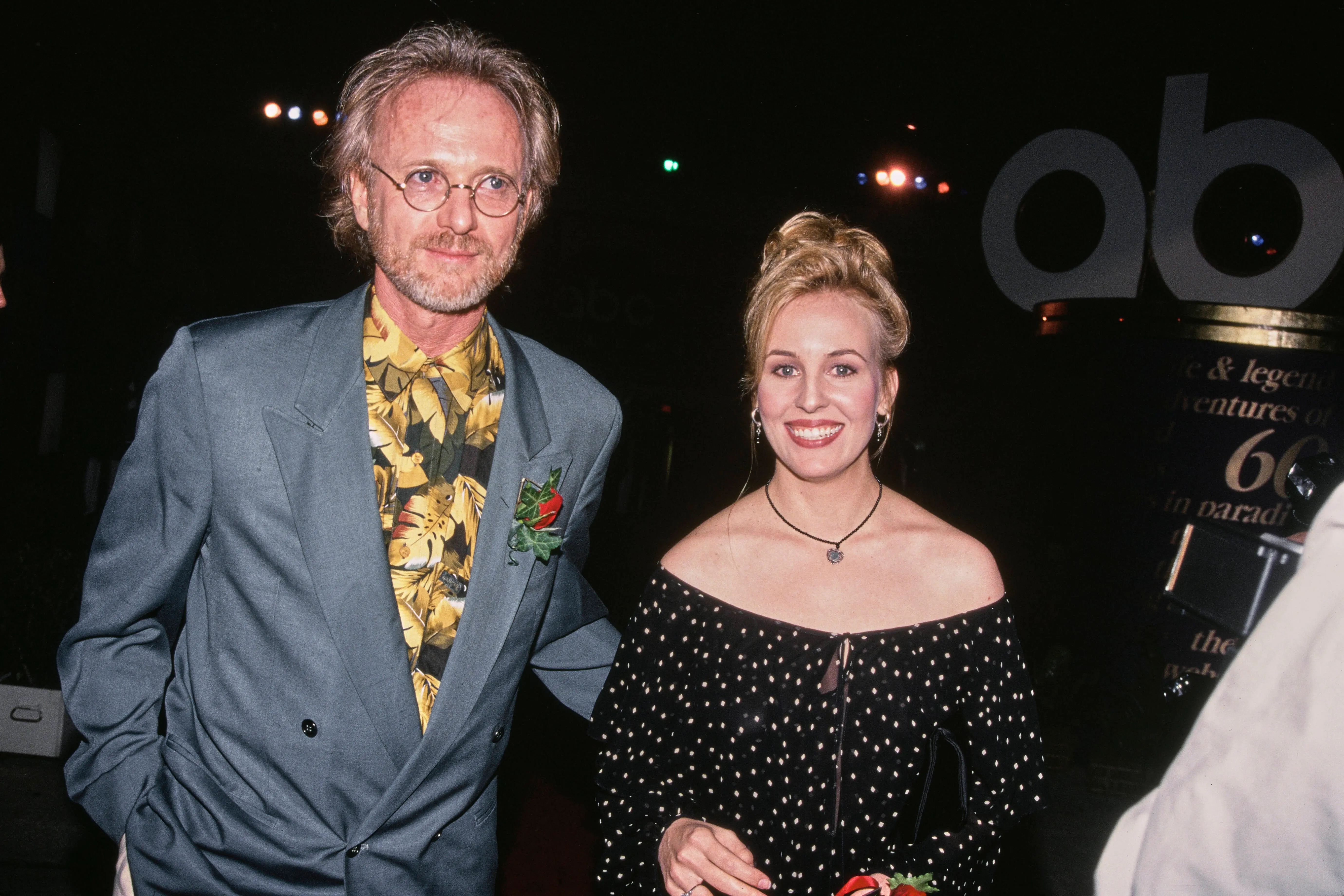 American actor Anthony Geary, wearing a blue blazer over a black-and-gold shirt, and American actress Genie Francis, who wears an off-shoulder black-and-white polka dot dress, attend an event in the United States, 1993. (Photo by Vinnie Zuffante/Getty Images)