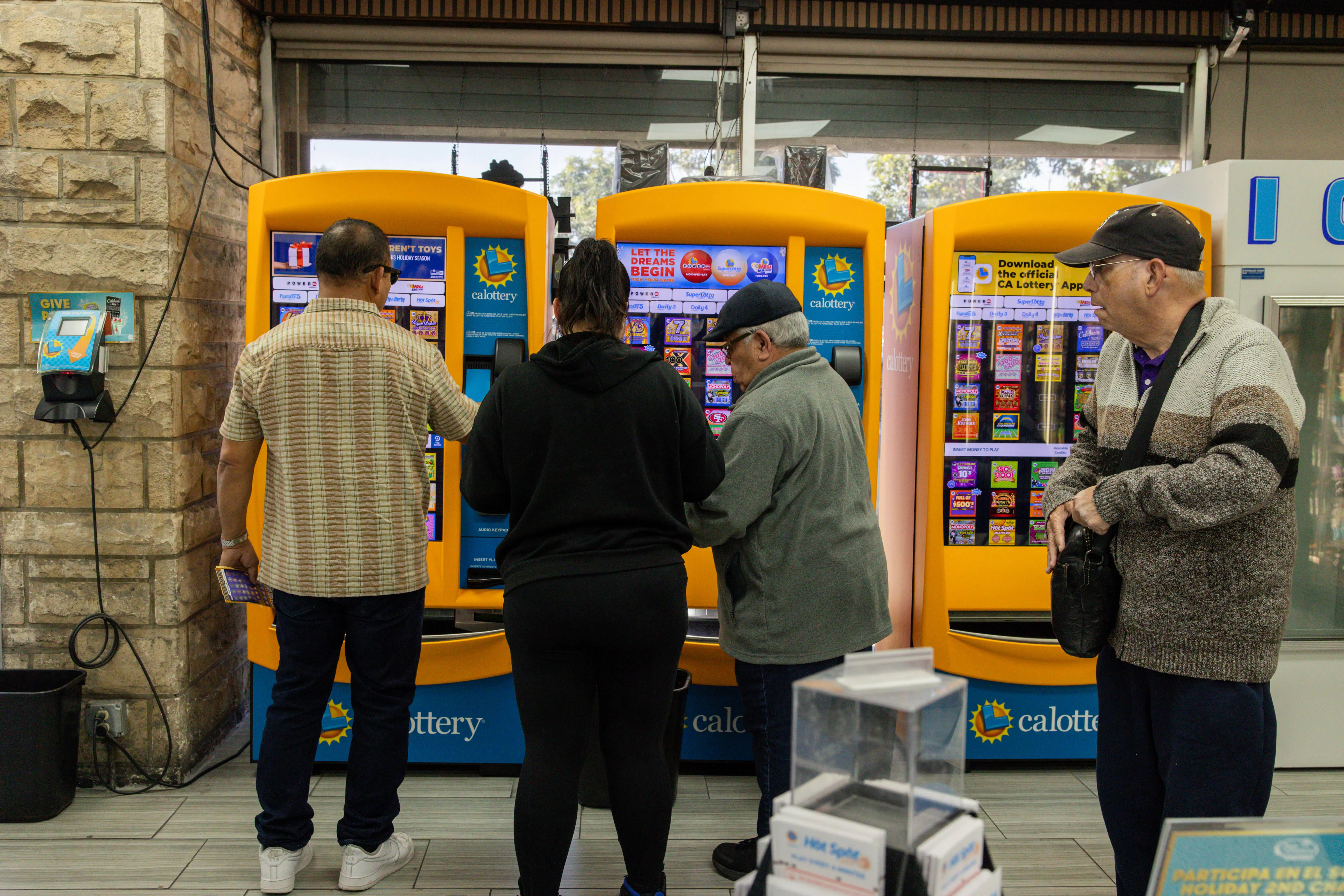 Hawthorne, CA - December 1: William Adelman, right, prepares to buy more lottery tickets at Bluebird Liquor on Monday, Dec. 1, 2025 in Hawthorne, CA. Adelman and his wife have been coming to Bluebird Liquor for years to play the lottery. (Juliana Yamada / Los Angeles Times via Getty Images)