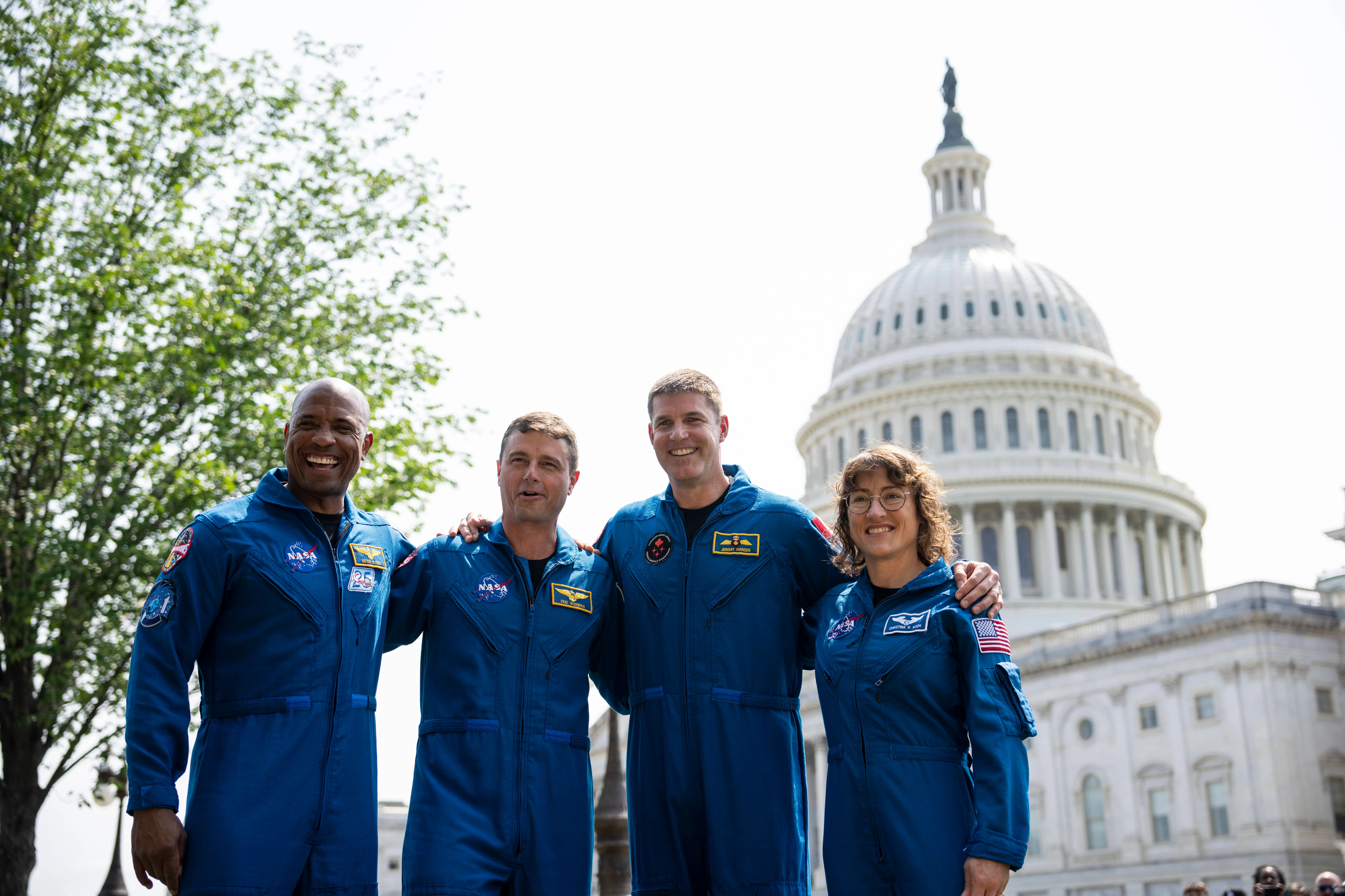 NASA astronauts Victor Glover, Reid Wiseman, Canadian Space Agency astronaut Jeremy Hansen and NASA astronaut Christina Hammock Koch pose for pictures after a news conference about the NASA's Artemis II mission outside the U.S. Capitol May 18, 2023 in Washington, DC. Planned for launch by the Space Launch System in November 2024, the Artemis II mission will include a crewed Orion spacecraft that will perform a lunary flyby and return to Earth (Image via Getty)