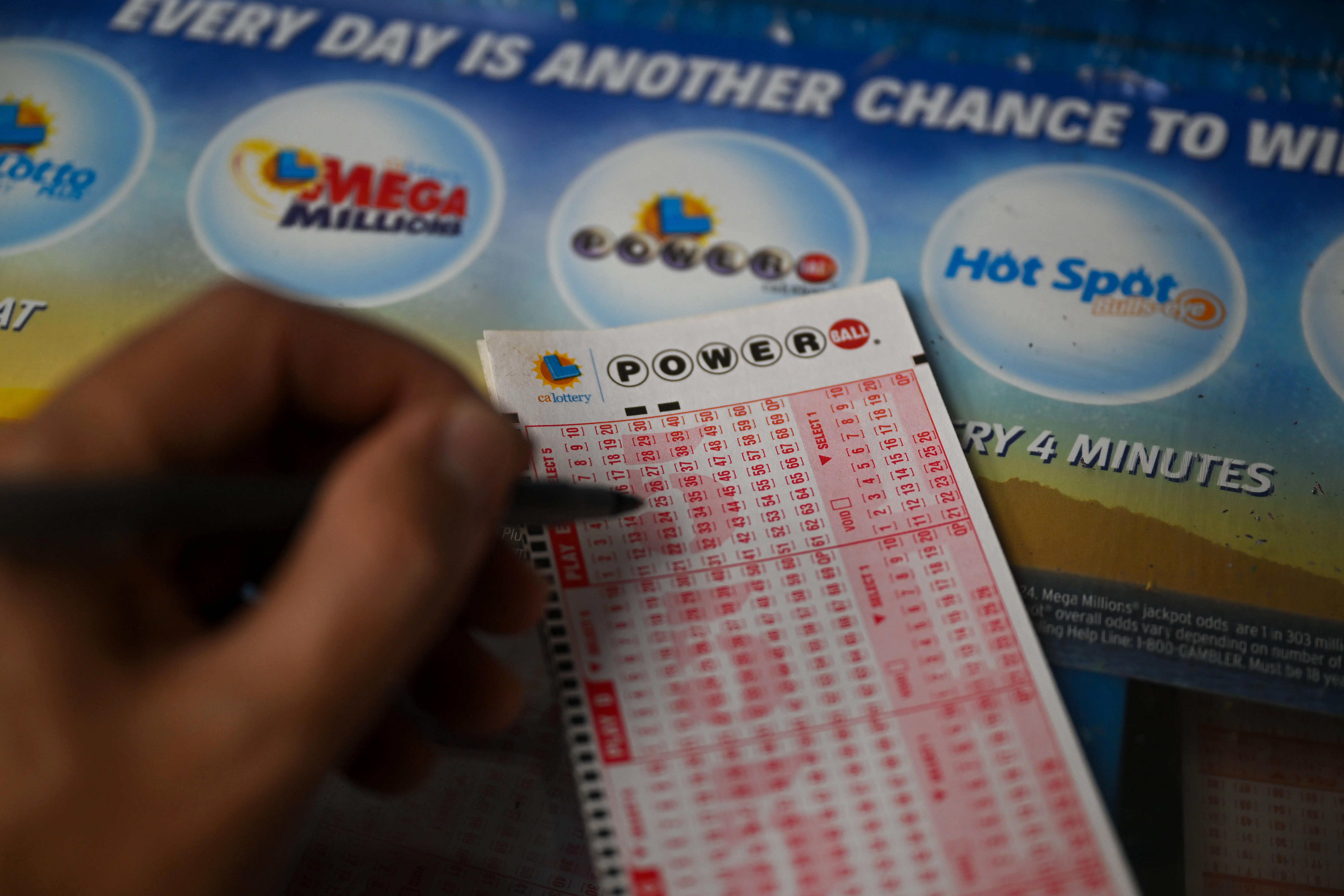CALIFORNIA, USA - JULY 11: A person plays Powerball lottery at a gas station as giant Powerball and Mega Millions jackpots grow more than $1B combined, in Trona, California, United States on July 11, 2023. (Photo by Tayfun Coskun/Anadolu Agency via Getty Images)