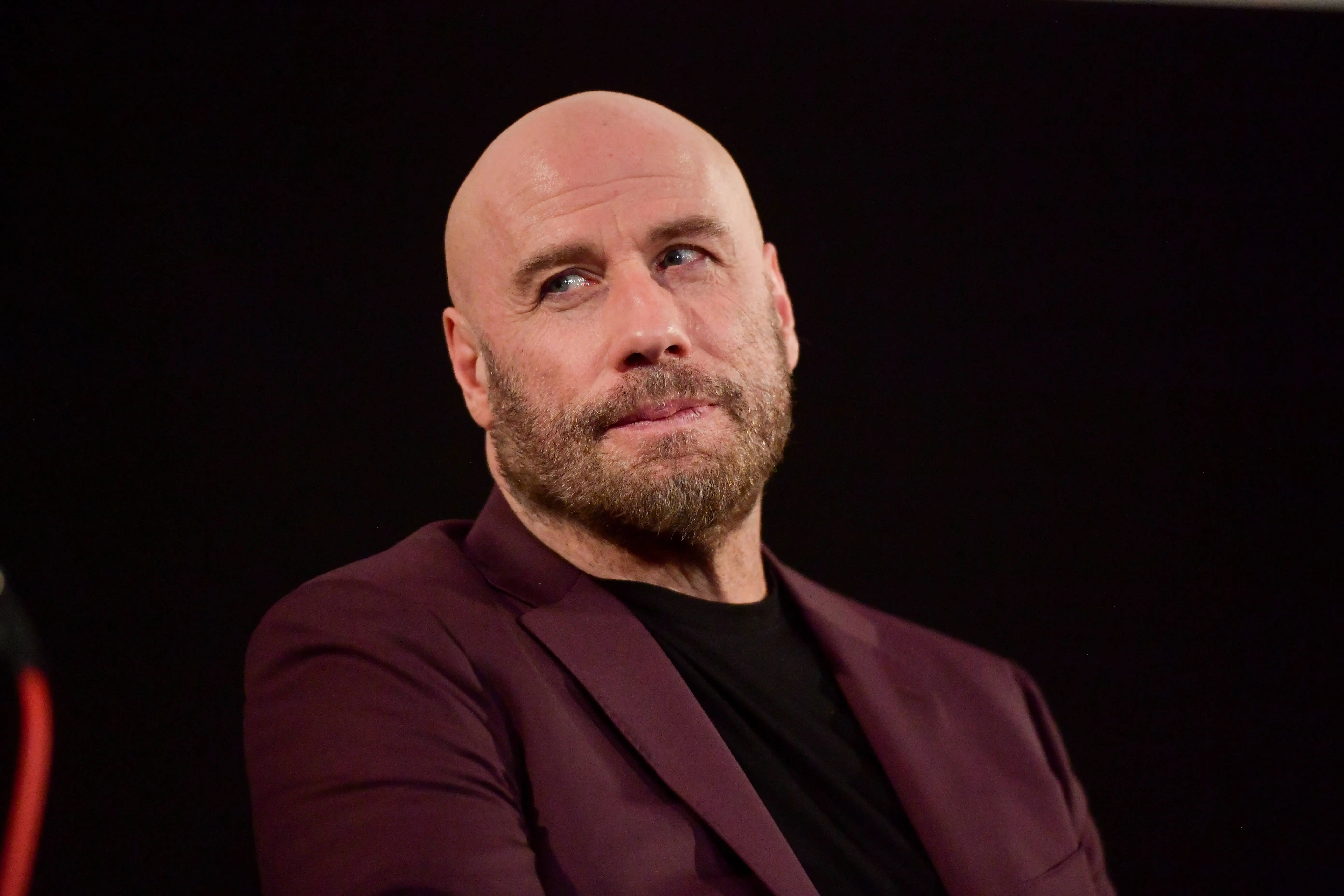 John Travolta speaks onstage during the premiere of Quiver Distribution's "The Fanatic" on August 22, 2019 (Image via Getty)
