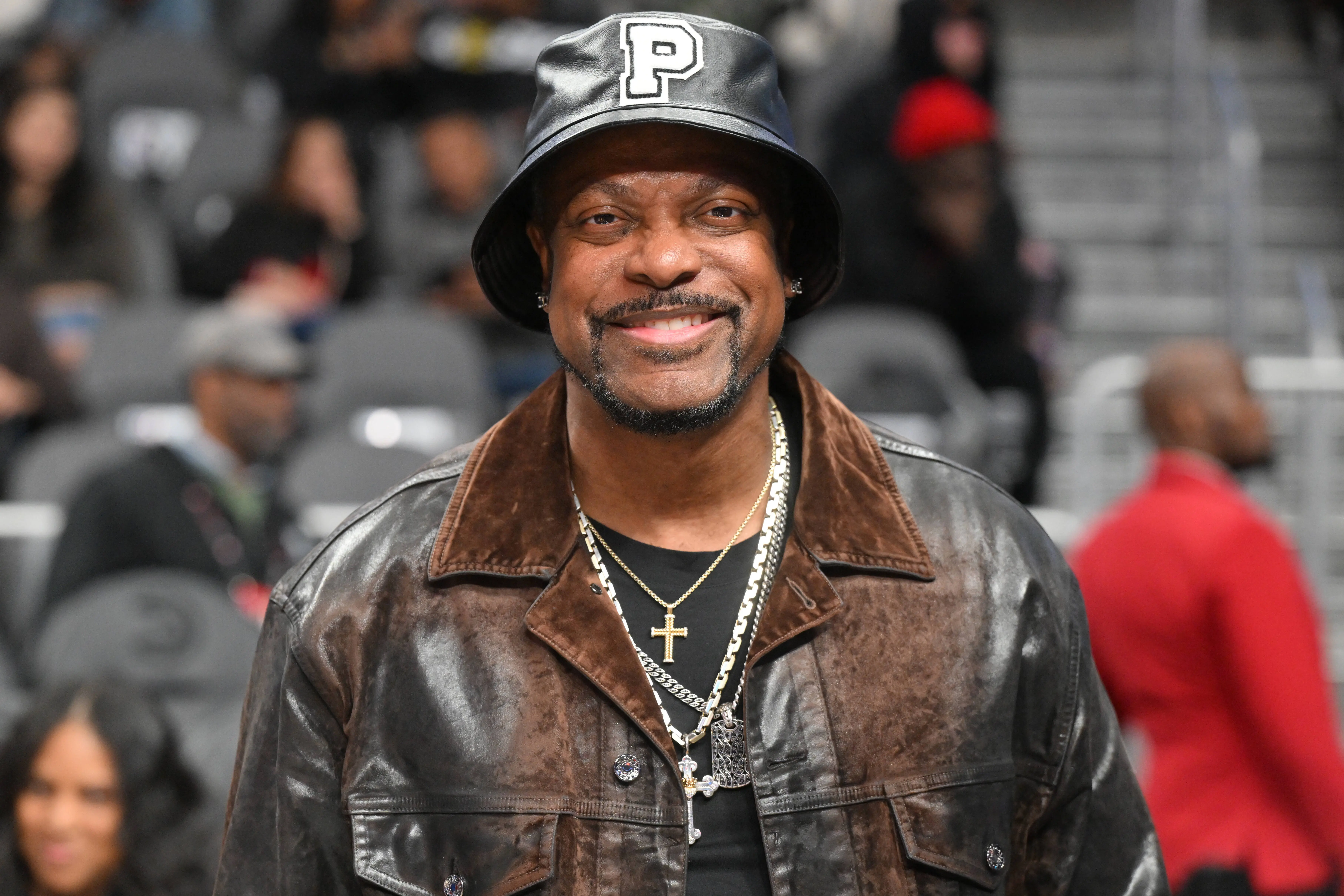 ATLANTA, GEORGIA - MARCH 10: Actor Chris Tucker attends the game between the Philadelphia 76ers and the Atlanta Hawks at State Farm Arena on March 10, 2025 in Atlanta, Georgia. NOTE TO USER: User expressly acknowledges and agrees that, by downloading and or using this photograph, User is consenting to the terms and conditions of the Getty Images License Agreement.  (Photo by Paras Griffin/Getty Images)