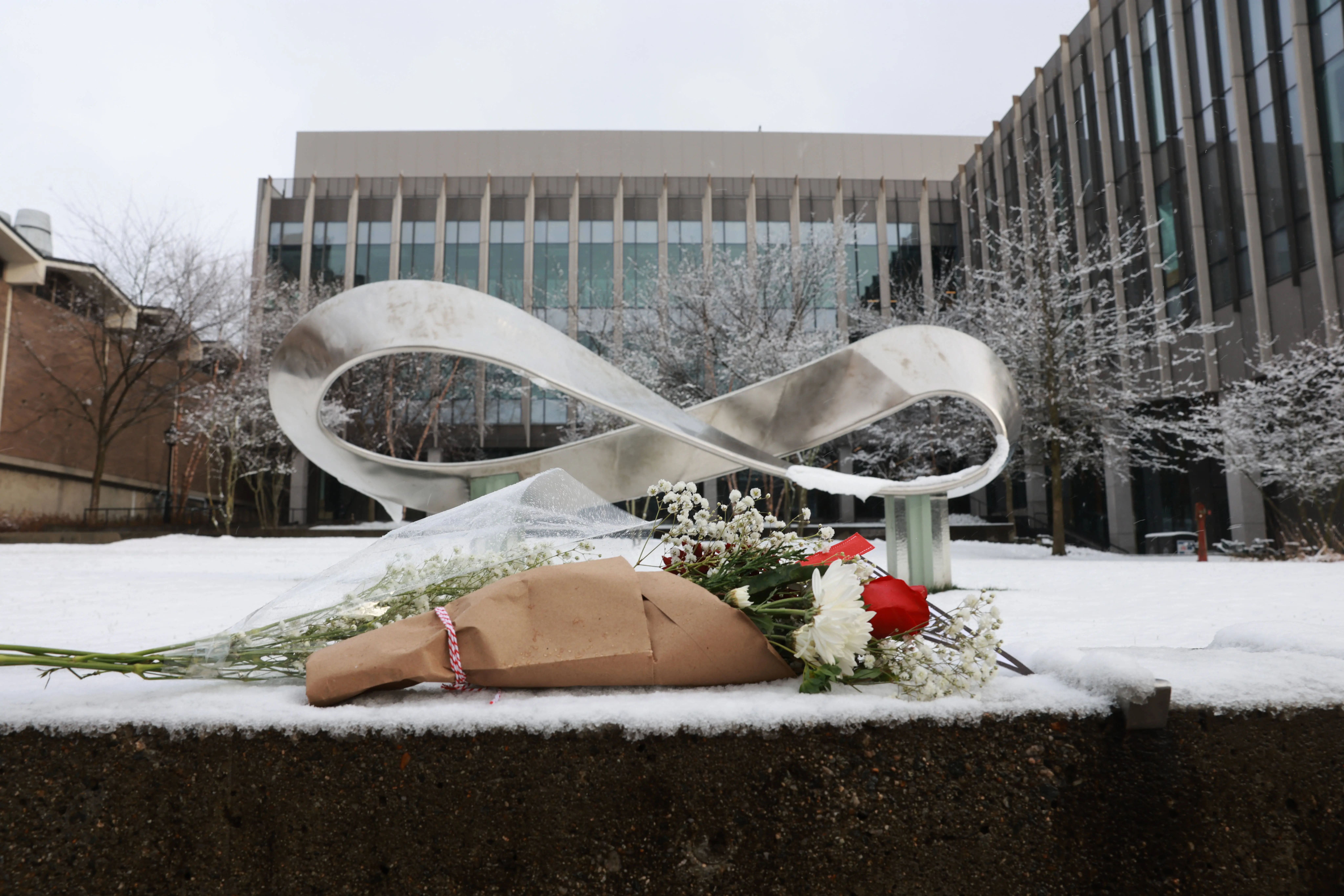 PROVIDENCE, RHODE ISLAND - DECEMBER 14: A bouquet is left outside of the engineering and physics building at Brown University, the site of a mass shooting yesterday that left at least two people dead and nine others injured, on December 14, 2025, in Providence, Rhode Island. A suspect in the shooting was detained overnight at a hotel in a nearby community following a manhunt across the prestigious university and the greater Providence area. The shooting took place around 4 p.m. on Saturday as students were preparing for exams and the holiday break. (Photo by Spencer Platt/Getty Images)