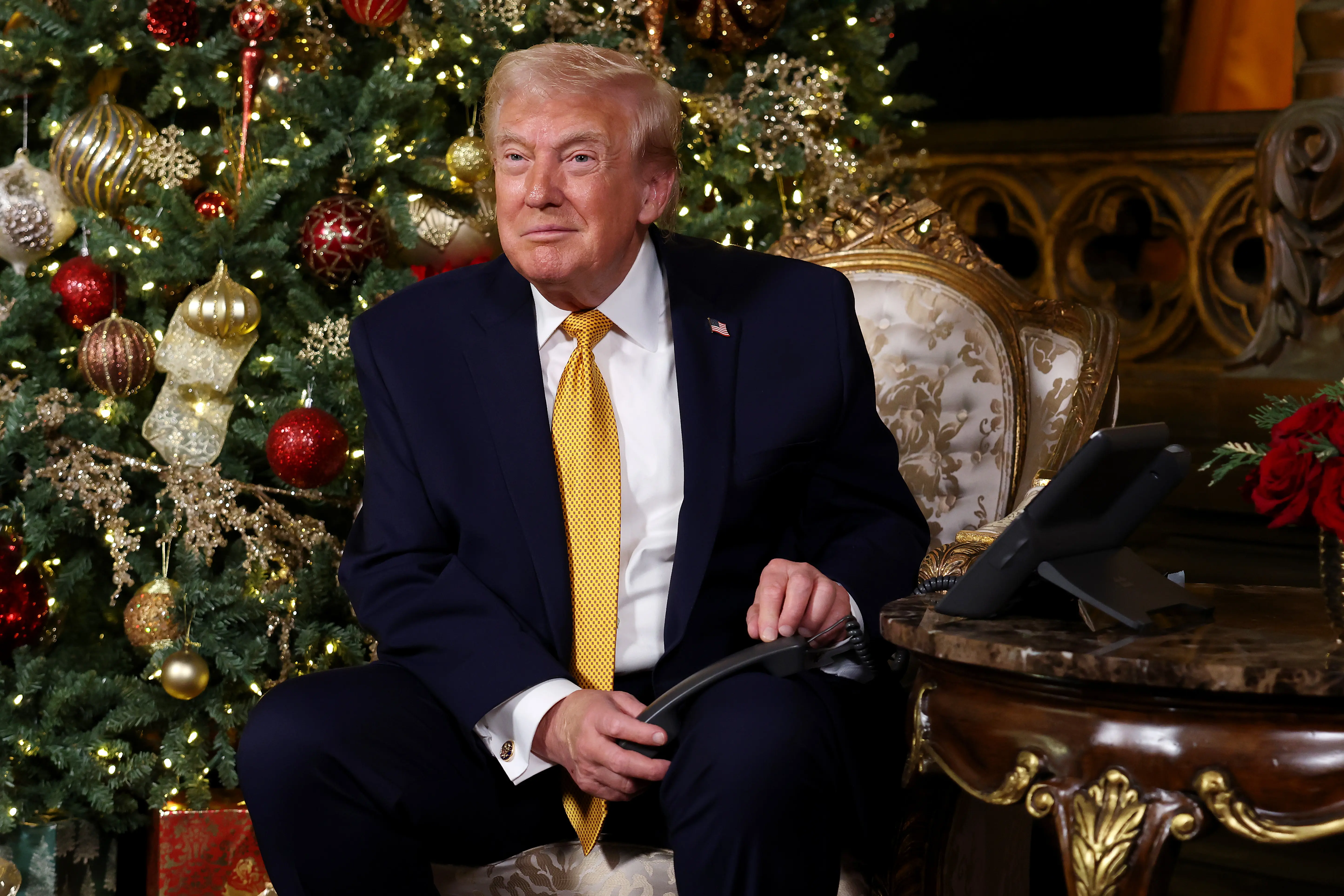 U.S. President Donald Trump calls children as he participates in tracking Santa Claus' movements with the North American Aerospace Defense Command (NORAD) Santa Tracker on Christmas Eve at the Mar-a-Lago resort on December 24, 2025 in Palm Beach, Florida. This is the 70th year that NORAD has publicly tracked Santa’s sleigh on its global rounds. (Photo by Tasos Katopodis/Getty Images)
