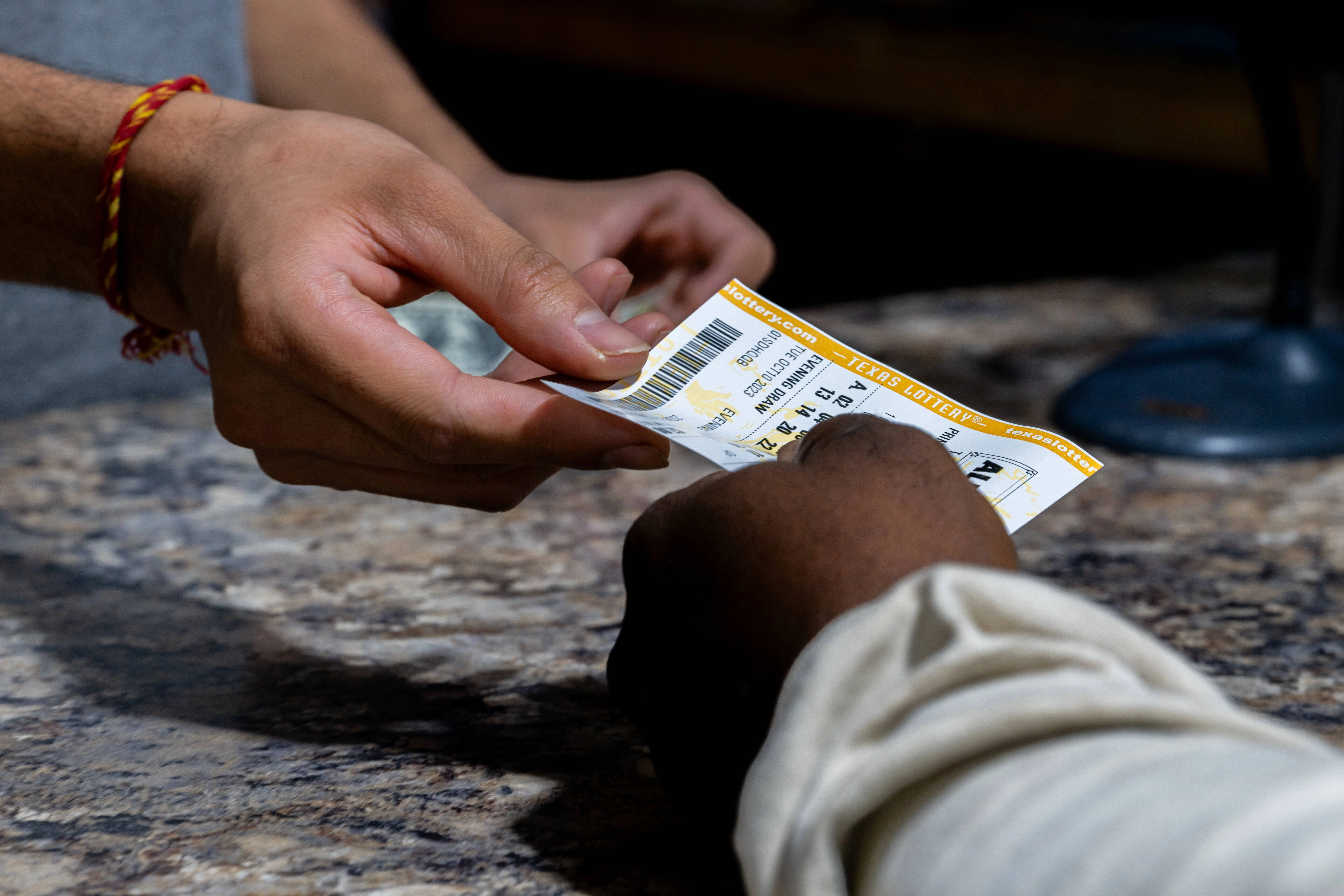 AUSTIN, TEXAS - OCTOBER 10: A customer purchases a Powerball lottery ticket at the Brew Market &amp; Cafe on October 10, 2023 in Austin, Texas. The Powerball jackpot has grown to over $1.7 billion, making it the second largest jackpot in history. (Photo by Brandon Bell/Getty Images)