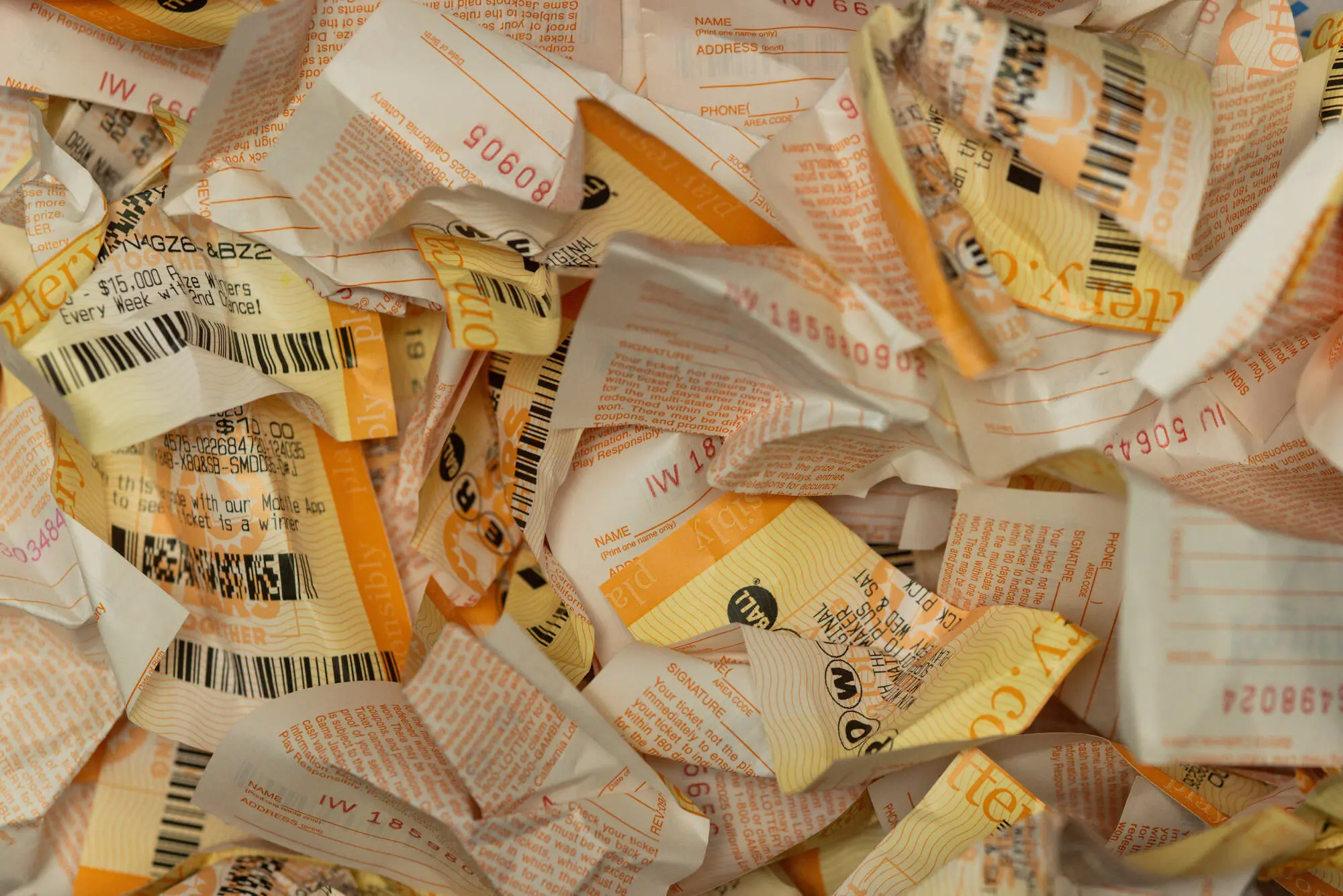 Hawthorne, CA - December 1: Crumpled up losing lottery tickets sit in a wastebasket at Bluebird Liquor on Monday, Dec. 1, 2025 in Hawthorne, CA. The Powerball jackpot has reached $740 million after no weekend winner was chosen. (Juliana Yamada / Los Angeles Times via Getty Images)