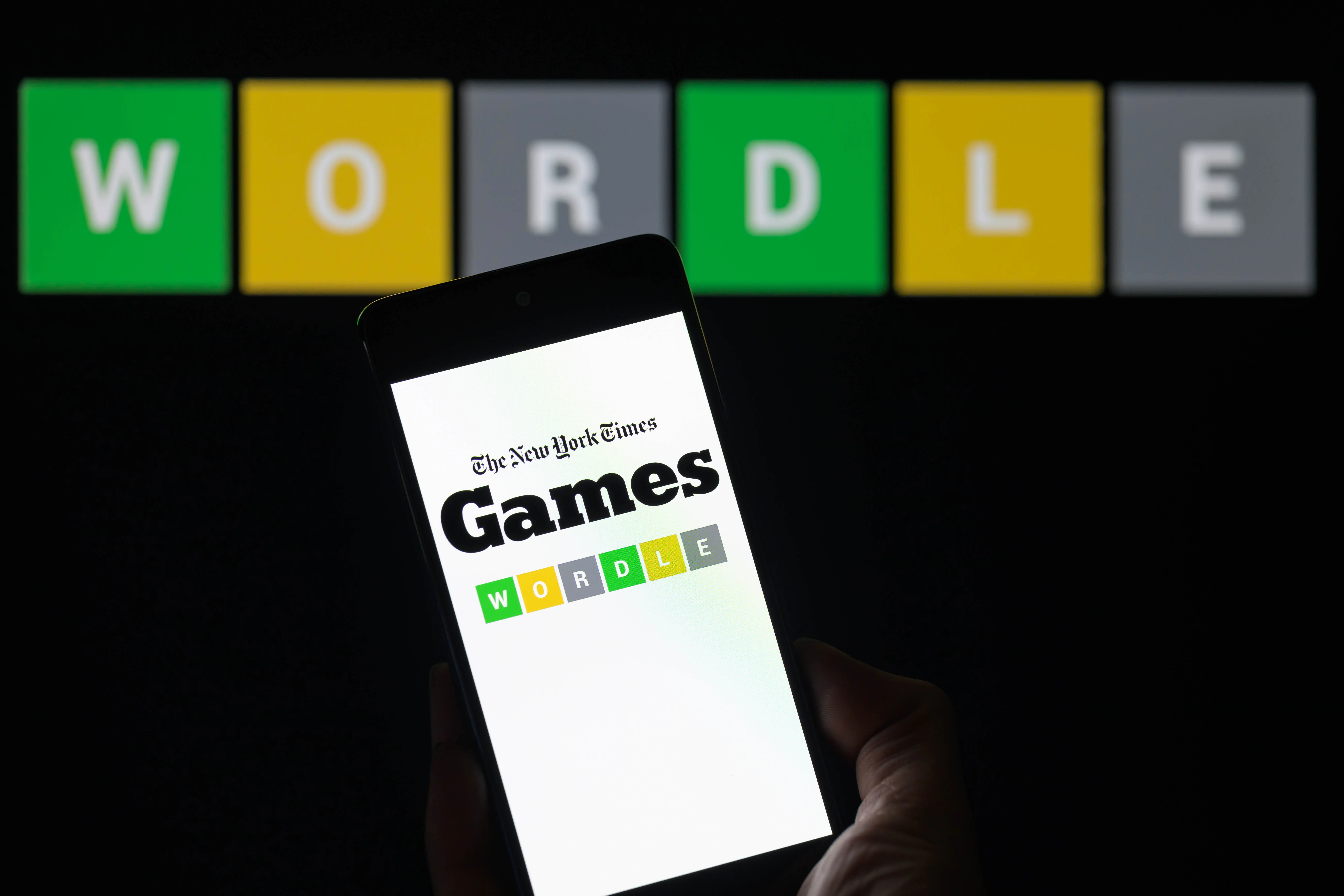 The New York Times Wordle logo is being displayed on a smartphone with Wordle visible in the background in this photo illustration in Brussels, Belgium, on June 1, 2024. (Photo by Jonathan Raa/NurPhoto via Getty Images)