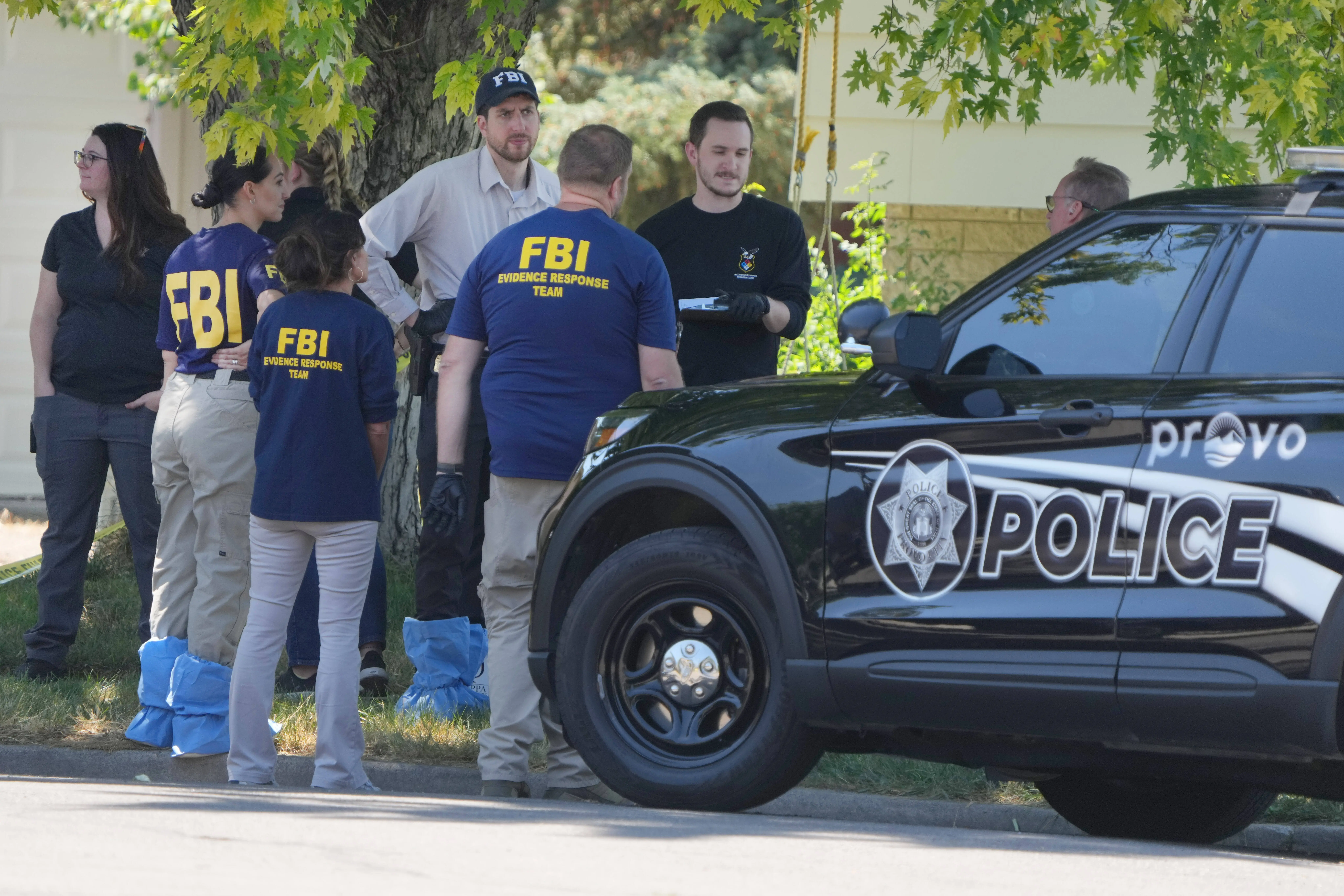 PROVO, UTAH - AUGUST 9: FBI officials and other law enforcement officers stand outside the home of Craig Robertson who was shot and killed by the FBI in a raid on his home this morning on August 9, 2023 in Provo, Utah. The FBI was investigating alleged threats by Robertson to President Biden who is visiting Salt Lake City today and tomorrow. (Photo by George Frey/Getty Images)