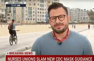 A woman fell while trying to take a bike selfie on live TV. (Photo: MSNBC).