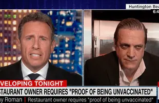 Chris Cuomo and anti-vax restaurant owner Tony Roman. (Photo: CNN)