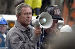 President George W. Bish Bush addresses rescue workers at Ground Zero on September 14, 2001. (Photo: SFC Thomas R. Roberts/ NGB-PASE)	