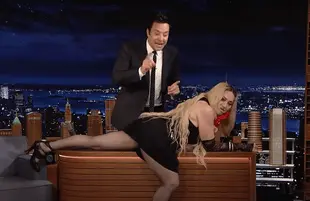 Madonna lays across Jimmy Fallon's desk on The Tonight Show (Photo: NBC)