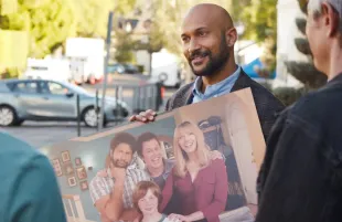 Then and Now: Reed (Keegan-Michael Key) holds a "vintage" cast photo from Step Right Up, the fictional '90s era sitcom at the heart of Reboot. (Photo: Hulu)