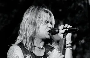 Lead singer David Roach is shown performing on stage during a live concert appearance with Junkyard on July 28, 1991 in Bristol, Connecticut. (Photo by John Atashian/Getty Images)