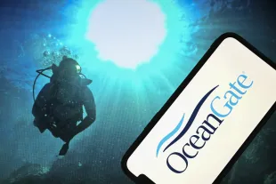 Logo of OceanGate in front of an underwater photo background in Turkiye (Image via Getty)