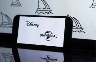 Photo illustration of Disney & Universal logos (Image via Getty)