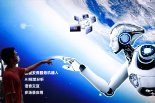 A boy points to the AI robot Poster during the 2022 World Robot Conference. (Photo by Lintao Zhang/Getty Images)