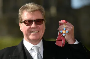 Michael Crawford poses after being made Commander of the Order of the British Empire (CBE) during an Investiture ceremony at Windsor Castle on March 7, 2014 in Windsor, England. (Photo by Andrew Matthews - WPA Pool/Getty Images)