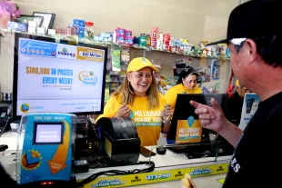 LOS ANGELES, CA - JULY 20: Maria Menjivar, owner, talks with a customer where a $1-billion Powerball ticket was sold at her store Las Palmitas Mini Market in downtown on Thursday, July 20, 2023 in Los Angeles, CA. The winner, who remains unidentified, purchased their ticket at Las Palmitas Mini Market at East 12th Street and Wall Street. (Gary Coronado / Los Angeles Times via Getty Images)