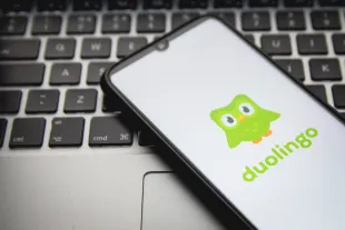 In this photo illustration a Duolingo logo seen displayed on a smartphone screen with a computer keyword in the background in Athens, Greece on December 9, 2021.  (Photo by Nikolas Kokovlis/NurPhoto via Getty Images)