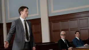 Milo Callaghan as Rudy Baylor (left) argues before the judge as John Slattery’s Leo Drummond watches from counsel table in The Rainmaker Episode 2, Nashville Hot. (Image via USA networks)