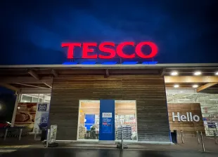 GLASTONBURY, UNITED KINGDOM - NOVEMBER 11: The Tesco logo is displayed outside a branch of the supermarket retailer Tesco on November 11, 2023 in Glastonbury, England. The British retailer, founded in 1919, is one of the largest in the world and is the market leader of groceries in the UK.
