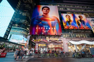 NEW YORK, NEW YORK - JULY 09: People cross the street near billboards advertising the new "Superman" film in Times Square on July 09, 2025 in New York City. (Photo by Craig T Fruchtman/Getty Images)