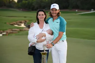 DUBAI, UNITED ARAB EMIRATES - NOVEMBER 19:  Tommy Fleetwood of England poses with the Race to Dubai trophy, partner Clare Craig and son Franklin during the final round of the DP World Tour Championship at Jumeirah Golf Estates on November 19, 2017 in Dubai, United Arab Emirates.  (Photo by Ross Kinnaird/Getty Images)