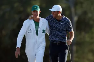 Scottie Scheffler and his caddie Ted Scott celebrate after winning the Masters at Augusta National Golf Club on April 10, 2022 in Augusta, Georgia (Image via Getty)