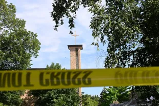 The Annunciation Catholic Church is seen behind police tape following a mass shooting on August 27, 2025 in Minneapolis, Minnesota (Image via Getty)