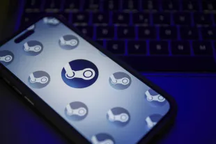 Steam logo is being displayed on a mobile phone screen (Image via Getty)