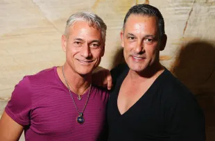 Greg Louganis poses alongside Johnny Chaillot during a Speak Out event (Image via Getty)