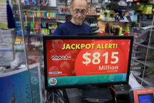 MIAMI, FLORIDA - AUGUST 26:  Robert Hadad sells Powerball lottery tickets at his Downtown Miami Souvenirs store on August 26, 2025 in Miami, Florida. The Powerball jackpot has climbed to $815 million ahead of Wednesday's drawing, making the jackpot the 10th-largest in Powerball history. (Photo by Joe Raedle/Getty Images)