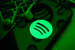ANKARA, TURKIYE - MAY 01: In this photo illustration a mobile phone screen displaying Spotify logo with a headset onto it, in Ankara, Turkiye on May 01, 2024. (Photo by Dilara Irem Sancar/Anadolu via Getty Images)