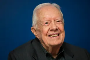 Former U.S. President Jimmy Carter smiles during a book signing event for his new book 'Faith: A Journey For All' (Image via Getty)