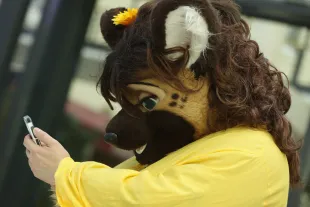 BERLIN, GERMANY - AUGUST 17:  A participant, or furry, as the participants prefer to be called, attempts to use a smartphone upon his arrival at the Estrel Hotel for the 2016 Eurofurence furries gathering on August 17, 2016 in Berlin, Germany. Approximately 2,500 furries from all over the world will participate in the four-day convention that includes dance parties, fashion shows and art events. Furries describe themlelvs as anthroporphic actors and the movemment has its roots in science fiction and fantasy genres going back to the 1980s.  (Photo by Sean Gallup/Getty Images)