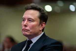 Elon Musk listens as US President-elect Donald Trump speaks during a House Republicans Conference meeting at the Hyatt Regency on Capitol Hill on November 13, 2024 in Washington, DC. (Photo by Allison Robbert-Pool/Getty Images)