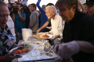 FORT LAUDERDALE, FL - NOVEMBER 12:  Arnold Abbott (2nd R), a 90-year-old chef, dishes out food to the homeless in violation of a recently passed city law on November 12, 2014 in Fort Lauderdale, Florida. The city said they passed the ordinance for sanitary and security reason, but Mr. Abbott continued to feed the homeless in a city park where he has twice been cited for violating the new ordinance. (Photo by Joe Raedle/Getty Images)