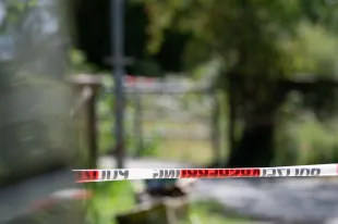 29 August 2025, Filderstadt: Police cordon tape can be seen in front of a bridge on the outskirts of Filderstadt. A suitcase with a body inside was found under a bridge by a small stream in Filderstadt. Photo: Markus Lenhardt/dpa (Photo by Markus Lenhardt/picture alliance via Getty Images)