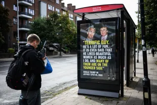 LONDON, ENGLAND - SEPTEMBER 03: Members of the public read the latest in a series of posters highlighting US President Donald Trump's relationship with dead sex trafficker Jeffrey Epstein, on September 03, 2025 in London, England, ahead of Trump's state visit planned for later this month. The protest group that calls itself 'Everyone Hates Elon' has gained notoriety by employing guerrilla tactics to install satirical 'ads' at bus stops across London and other venues that target political figures, with an initial focus on Elon Musk during his time in the Trump administration. Last month they orchestrated the installation of a viral meme depicting a distorted image of JD Vance on a poster in the Cotswolds, during the US Vice President's UK holiday. (Photo by Leon Neal/Getty Images)