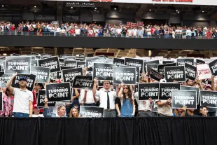 ARIZONA, UNITED STATES - SEPTEMBER 21: Charlie Kirk supporters seen holding the 'This is our Turning point' signs during the memorial service for conservative activist Charlie Kirk at State Farm Stadium in Glendale, Arizona, United States, on September 21, 2025. (Photo by Jon Putman/Anadolu via Getty Images)