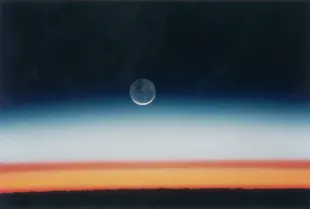 The moon rises over the earth shortly before sunrise, as seen from the space shuttle Columbia during NASA's STS-52 mission, October 1992. The shuttle is orbiting Earth at an altitude of 285 km over Lake Tanganyika in central Africa. The sun is just below the horizon, and the brown layer marks the tropical tropopause. (Photo by Space Frontiers/Getty Images)