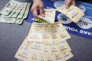 Hawthorne, CA - October 10: Most people paid cash for their Powerball plays, but debit cards are also accepted at Blue Bird Liquor in Hawthorne, CA, Tuesday, Oct. 10, 2023. The estimated jackpot for tonight's Powerball drawing is $1.73 Billion.(Jay L. Clendenin / Los Angeles Times via Getty Images)