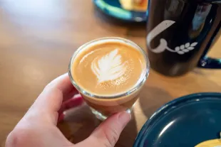 Peron's hand holding at Cortado coffee drink at Maison Benoit bakery in Danville, California, June 4, 2025. (Photo by Smith Collection/Gado/Getty Images)