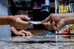 AUSTIN, TEXAS - OCTOBER 10: A customer purchases a Powerball lottery ticket at the Brew Market & Cafe on October 10, 2023 in Austin, Texas. The Powerball jackpot has grown to over $1.7 billion, making it the second largest jackpot in history. (Photo by Brandon Bell/Getty Images)